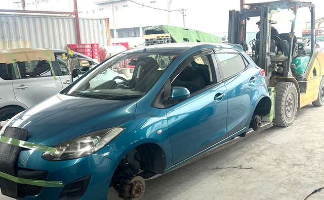 Two cars packed into a container